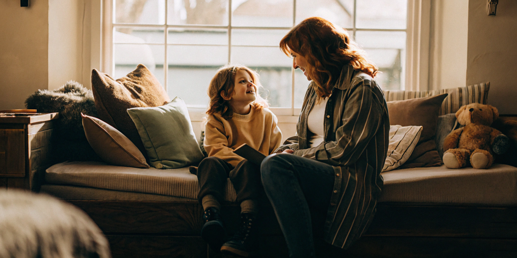 a-mother-and-a-child-are-sitting-next-to-each-othe.png