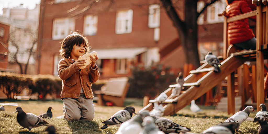 a-child-in-the-park-with-bread-in-his-hands.png